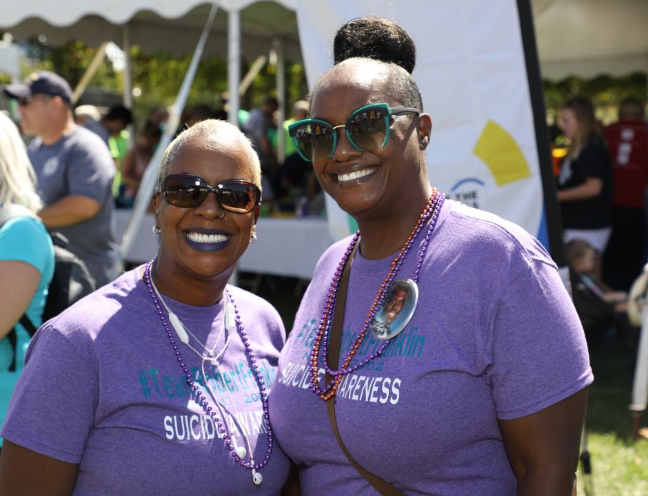 Two women in sunglasses and smiling